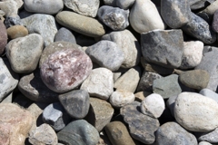Our River Jack gravels are nominally sized, meaning, typical sizes run 3 to 5 inches representing a middle/average size. There will be some within that size range, that are smaller, and some larger than the nominal size.Delaware Quarries River Jacks are not produced to any ASTM standard, as we sell our product as decorative landscape stone only. For this example lets use the 3 to 5 inch River Jacks. The screens are made up of squares, so in the instance of 3 to 5 inch, there is a possibility of a stone up to 7 inch plus, in one dimension if the stone, clearing the screen, if it hits the screen diagonally. This sizes only one dimension of the stone and the other dimension will vary, sometime greatly. In a load of our nominally sized 3 to 5 inch River Jacks, a small percentage may be smaller or larger due to the nature of quarrying and loading. This process results in our nominally sized River Jacks.